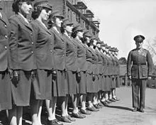 A group of women officer candidates brought to attention by a male instructor during the Second World War